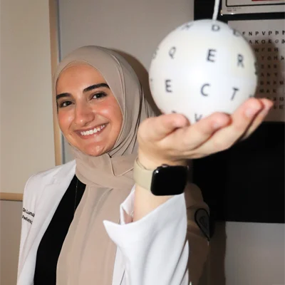 Dr. Luma Mallah holding a ball used in vision therapy